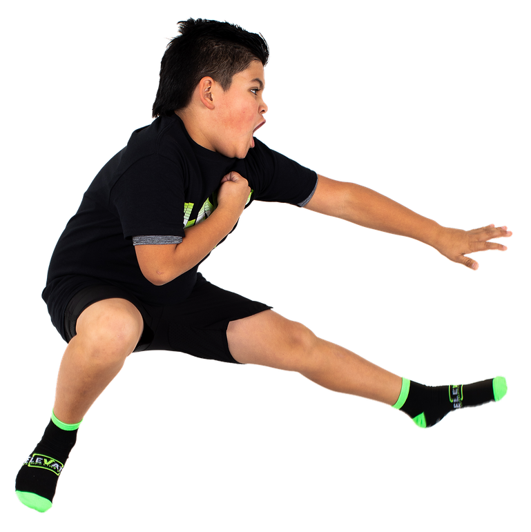 boy doing jump kick with elevate socks